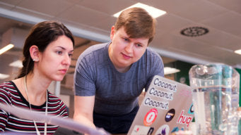 The School of UX tutor Sergei helping students at Prototyping UI workshop