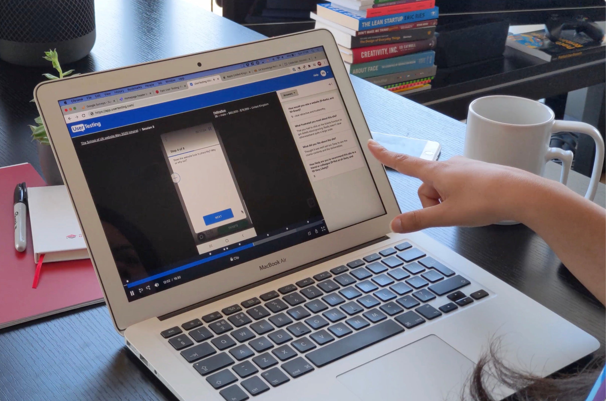 Usability testing session reviewing an interactive mobile prototype on a laptop
